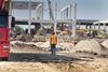 Construction engineer supervising work at building site
