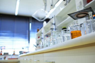 chemistry lab (shallow DOF; focus on the beakers in the foreground)